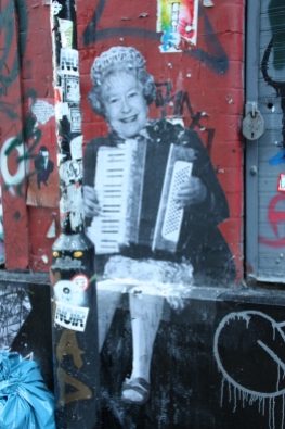 Her Majesty the Queen, sitting on a wall... playing the accordian!